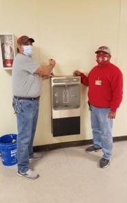 Mike & Tyree installing a water fountain.